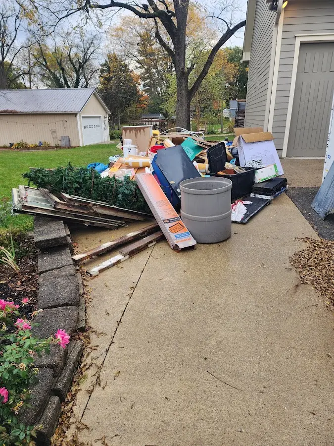 Dumpster being loaded with debris for Estate Cleanout Dumpster Rental in Tierra Verde
